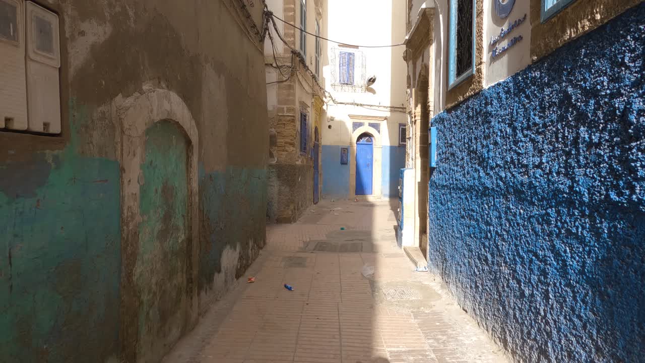 Walking pov shot along empty narrow streets of Essaouira medina, Morocco