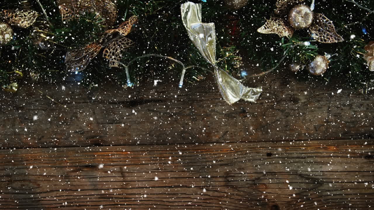 Video composition with snow over desk with Christmas decoration