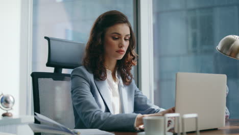 woman manager corresponding client using laptop sitting luxury office close up.