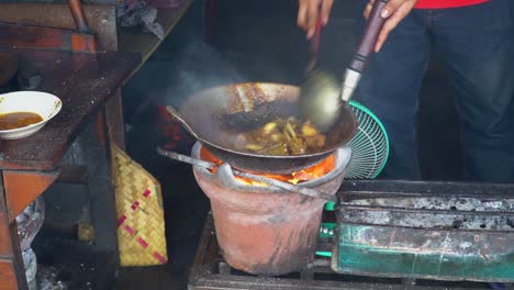 cooking traditional indonesian soup tengkleng goat on traditional charcoal stove