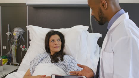 female patient and doctor have consultation in hospital room