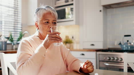 old woman with pills in kitchen