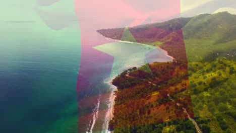 digital composition of waving cameroon flag against aerial view of the sea