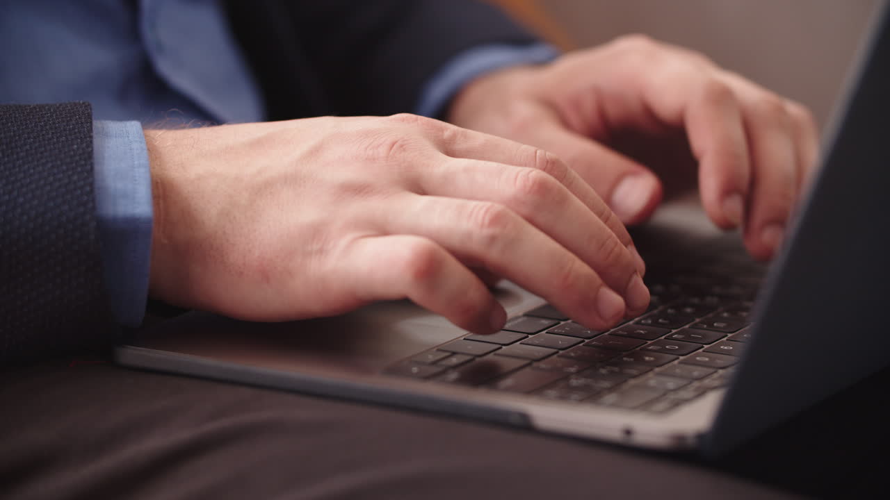 Man hands opening laptop in remote office. Businessman typing on computer