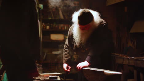 blacksmith at work in a dark workshop