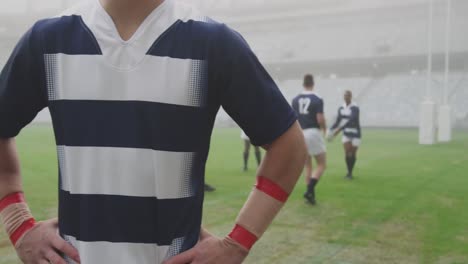 animation of football balls with flags of france falling over caucasian male rugby player