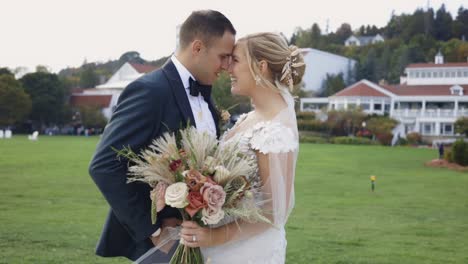 bride and groom laugh together in the sun