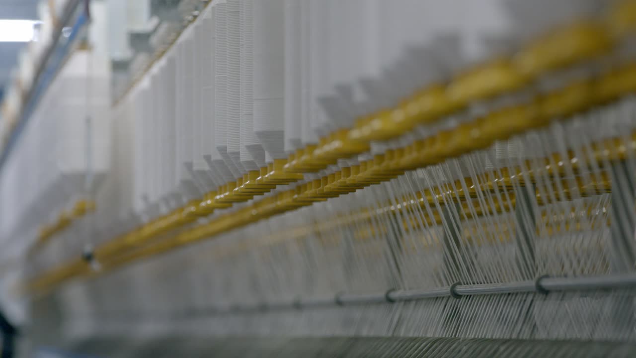 fábrica textil de hilos de algodón, cinematográfica, profundidad de enfoque superficial, hilo de algodón orgánico utilizado para la producción descentralizada de tejidos de hilos de algodón sostenibles y ecológicos