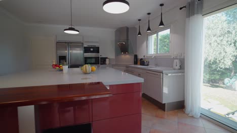 slow establishing shot of a small modern white kitchen within a house