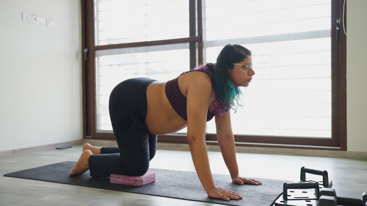 Third trimester Indian female does hip rotation yoga workout for health care training flexibility