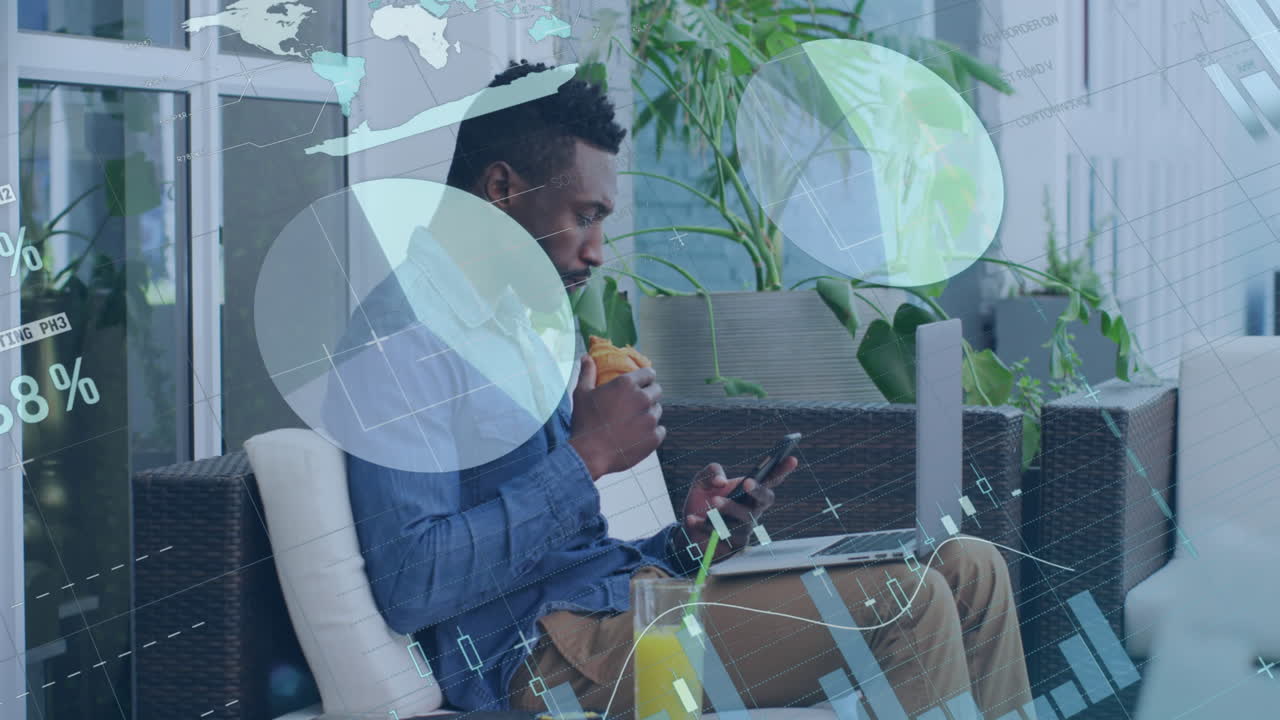 Statistical data processing against african american man using laptop and having a snack