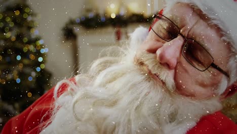 Video-composition-with-falling-snow-over-santa-asleep-in--room