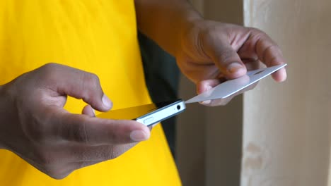 person using a mobile phone for online payment with a credit card