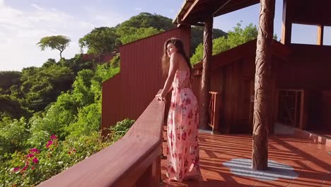 a beautiful woman walks to the balcony of a luxury hotel room at st lucia caribbean