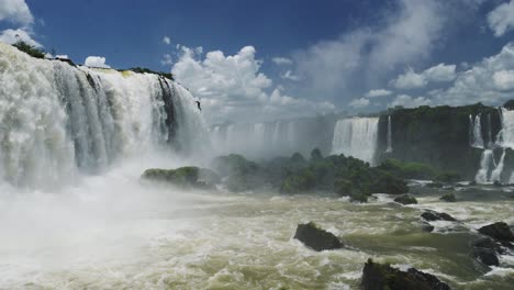 Huge-Bright-Waterfall-Valley-Hidden-in-Large-Green-Jungle,-Amazing-Nature-Scenery-and-Long-Rough-Waterfalls-Falling-on-Green-Coloured-Rocky-Floor-in-Iguacu-Falls,-Brazil,-South-America