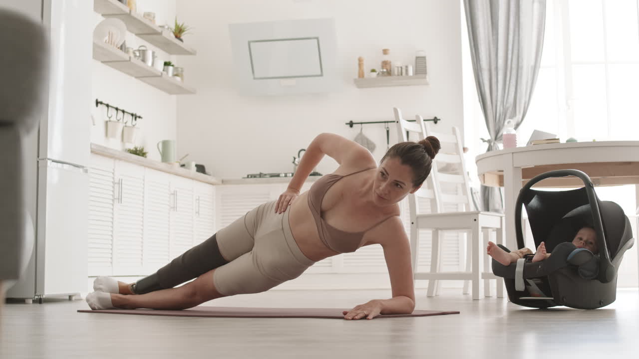 Sportswoman with Disability Doing Side Plank while Babysitting