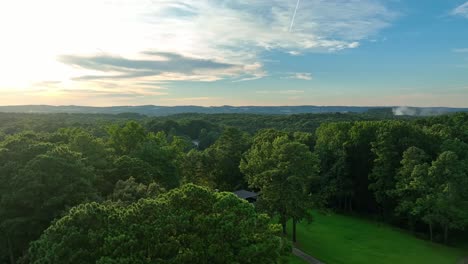 ascending drone flight over suburb district in atlanta city during golden sunset time - establishing aerial flyover - luxury american neighborhood in georgia