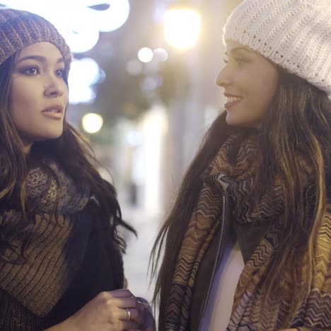 two smiling happy women in winter outfits