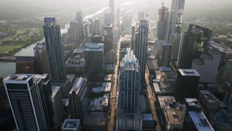 aerial view of a sprawling city skyline with a river on a hazy morning