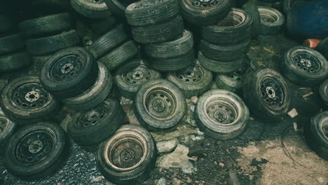 stacked old tires in a recycling yard during the afternoon sunlight