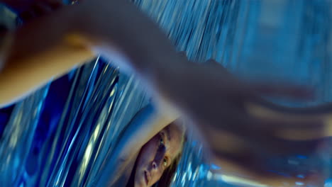 female dancer giving surreal contemporary performance in neon lit studio