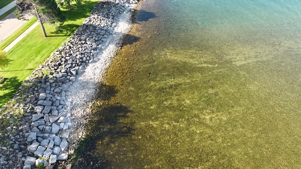 Forward motion, tracking along the stony shoreline