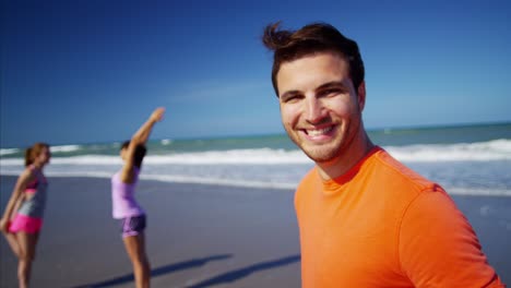 portrait of caucasian man on beach with friends