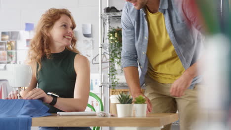 male and female students or business owners working in fashion having meeting in studio