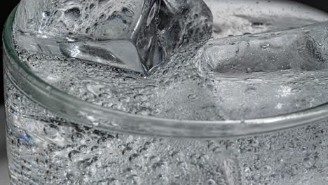 Glass-of-water-with-ice-on-a-dark-blue-background