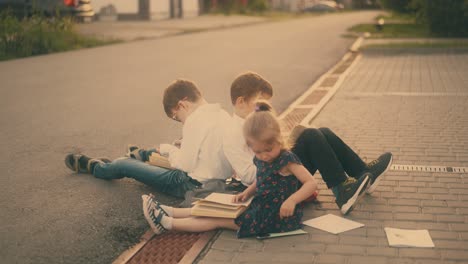 young guys with sister in black dress study on pavement