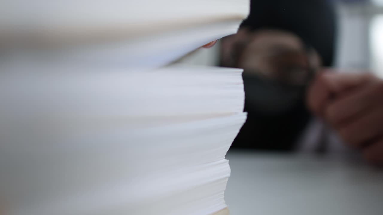 Stack of Documents Being Examined