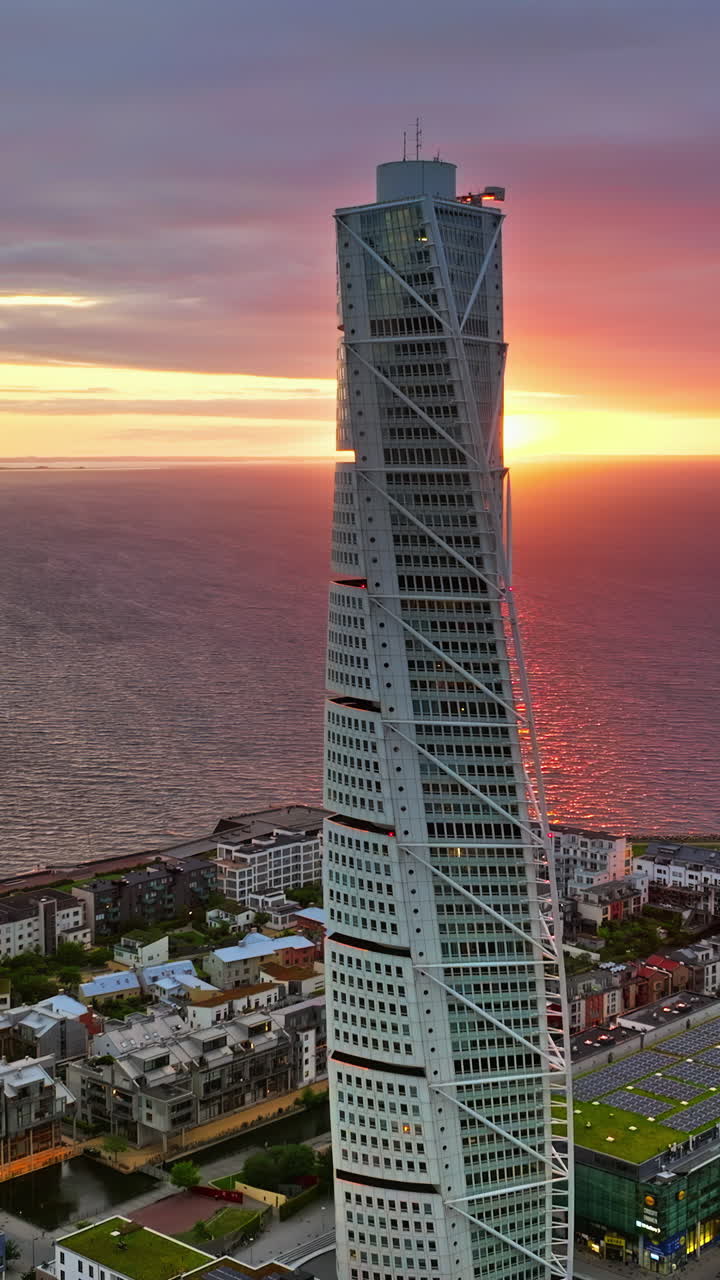 Aerial drone view of Turning Torso residential skyscraper in Malmo, Sweden at sunset. Vertical