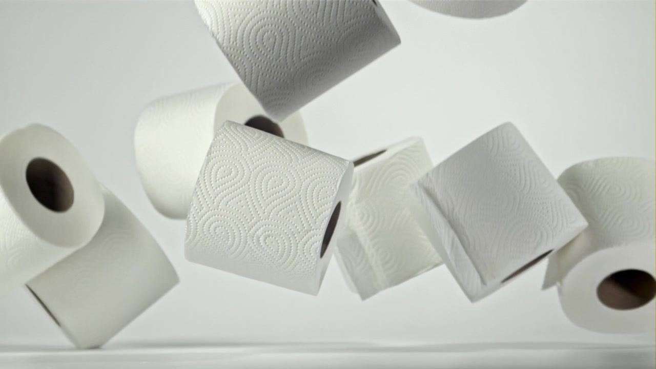 Multiple Rolls of Toilet Paper Falling and Bouncing in Slow Motion