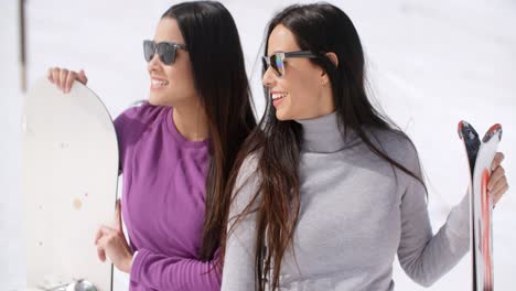 Two-attractive-young-women-with-their-snowboards