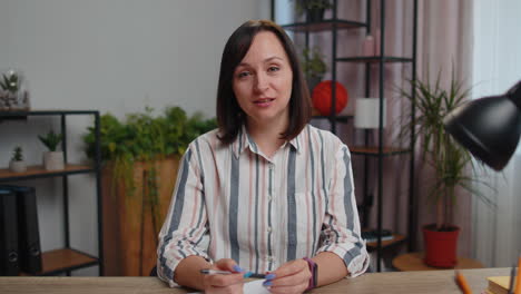 POV-of-young-businesswoman-working-from-home-office-making-video-webcam-conference-call-conversation