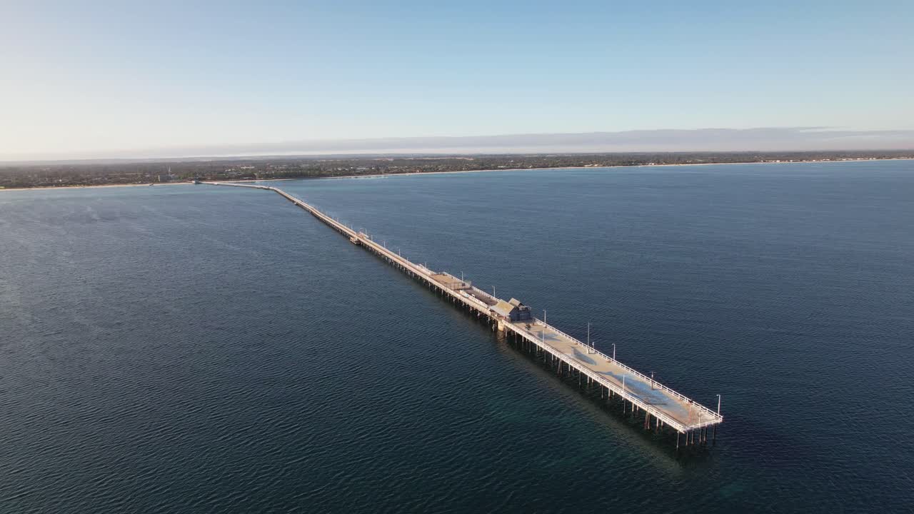 4K Drone video circling around Busselton Jetty surrounded by the vast blue ocean in Western Australia
