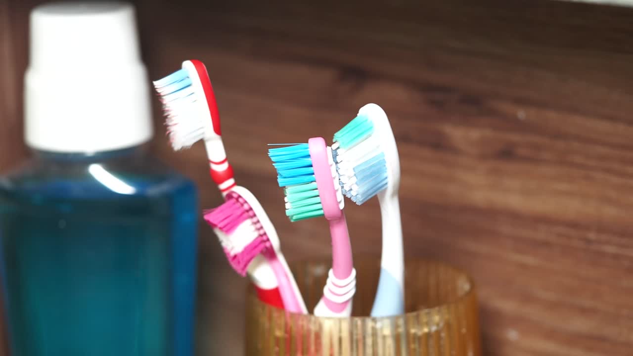 Toothbrushes and Mouthwash in a Bathroom Setting