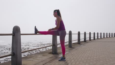 caucasian woman stretching on the docks