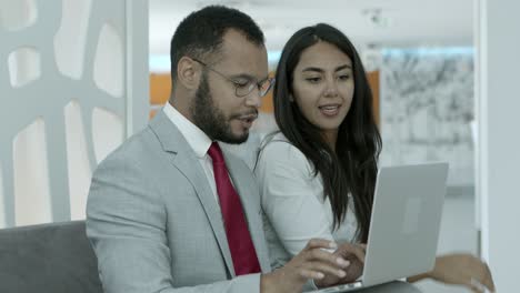 Young-business-colleagues-working-with-laptop