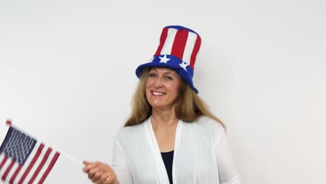 a woman sways a flag while smiling from a close-up perspective