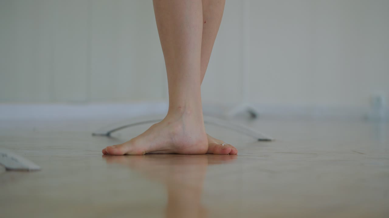 Barefoot female dancer in dance studio
