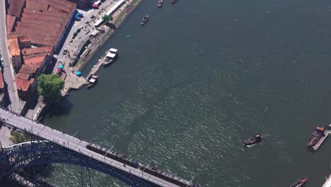 drone view of luís i bridge while train passing by, porto