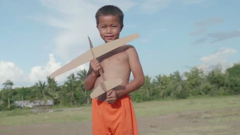 boy playing with a paper airplane