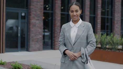 businesswoman in front of modern office building