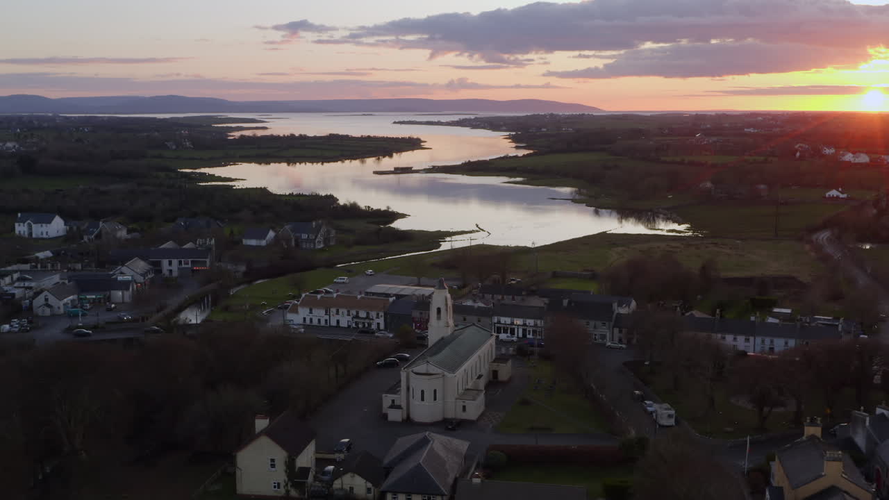 Overhead of water reflecting sky at dusk in Clarinbridge with sunset light and distant horizon