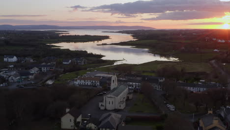 overhead of water reflecting sky at dusk in clarinbridge with sunset light and distant horizon