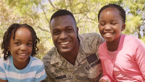 soldier man and his children looking at camera