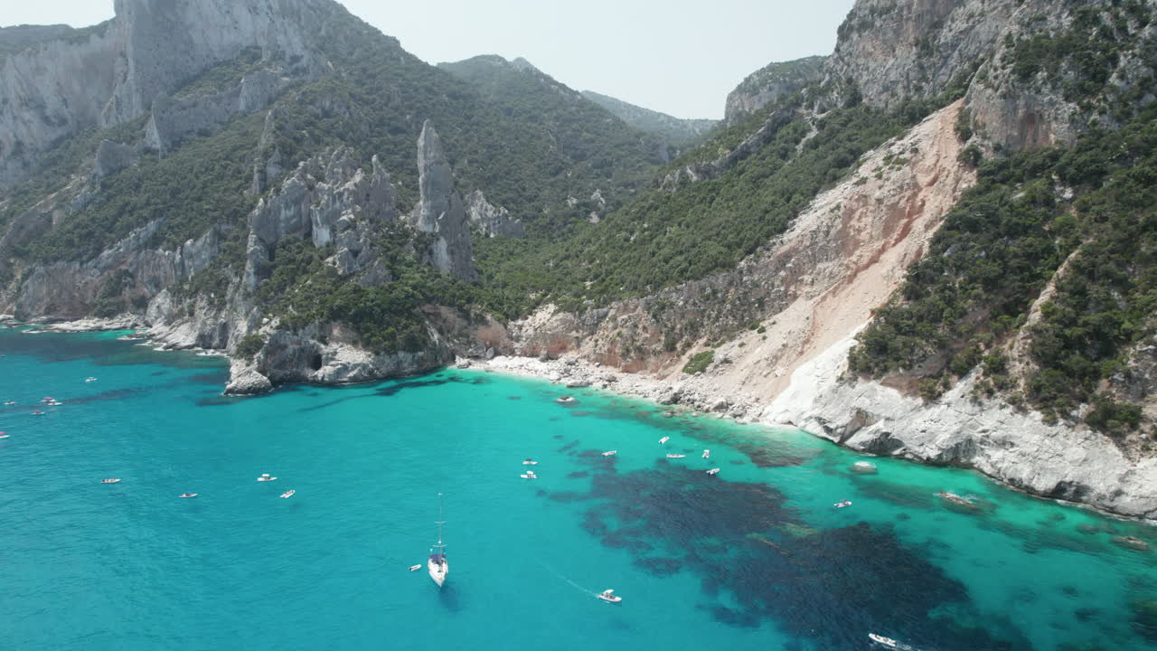 Aerial landscape drone video of tropical paradise turquoise beach and sea cliffs in the mediterranean, Cala Goloritz?