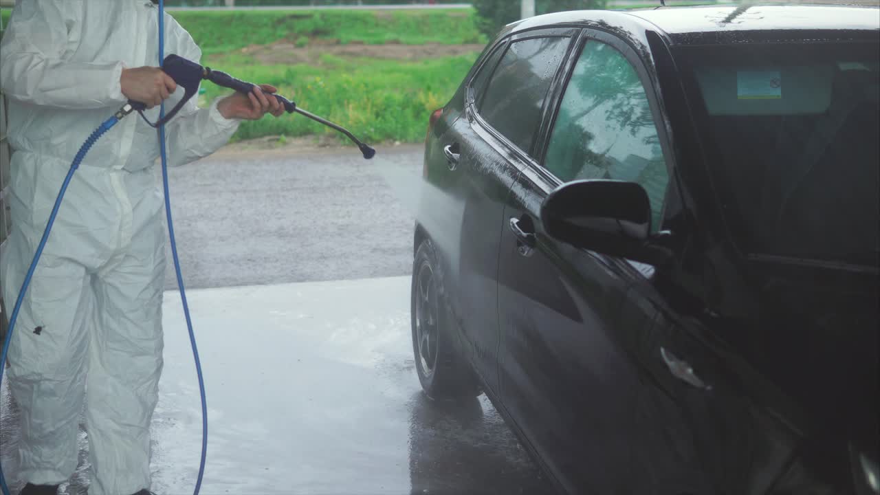 Man Washing a Car in a Car Wash Facility