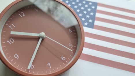 4k time-lapse of movement of the clock hands. clock on the background of the flag of the united states of america.